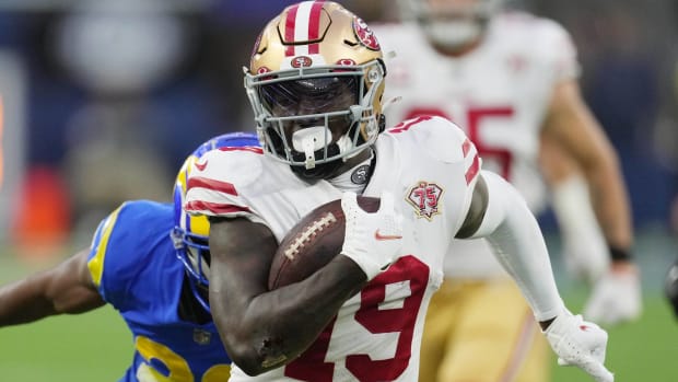 49ers wide receiver Deebo Samule runs away from a Rams defender.